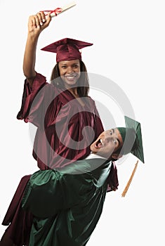 Multi racial couple in cap and gown