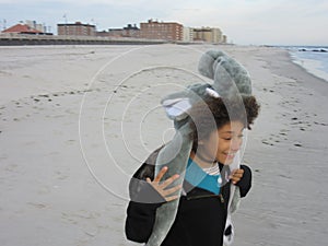 Multi Racial tween girl on beach by ocean