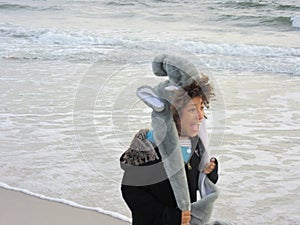 Multi Racial tween girl on beach by ocean