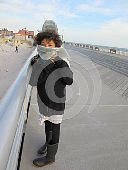 Multi Racial tween girl on boardwalk on beach