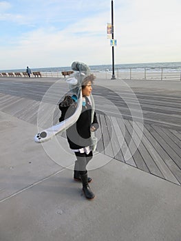 Multi Racial tween girl on boardwalk on beach