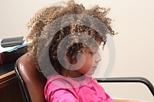 Multi Racial tween girl close up playing with green dots and  lights on face