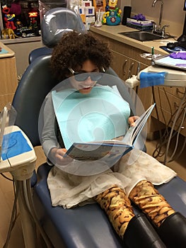 Multi Racial tween girl in dentist chair