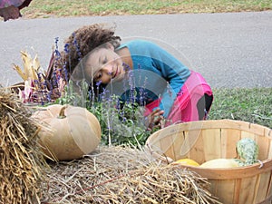 Multi Racial tween girl with pumpkins