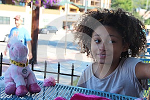 Multi Racial tween girl with stuffed animal smiling