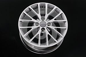 Multi-spoke gray alloy wheel on black background