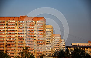 Multi-storey apartment buildings in a row form a street, a residential area. Residential multi-storey building. Urban perspective