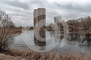 Multi-storey building reflecting in the river