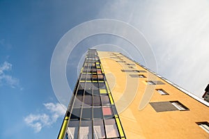 The multi-storey building is tall against the blue sky in good weather