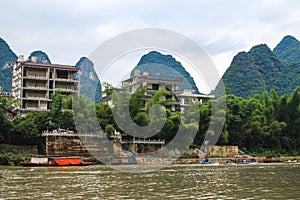 Multi-storey and multi-apartment houses on the scenic shore of the Li River