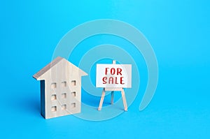 Multi-storey residential building and for sale sign. Realtor service. Sale of apartments and real estate. Investing in a rental