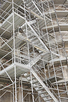 Multi-storey scaffolding with a vertical staircase near the old building photo