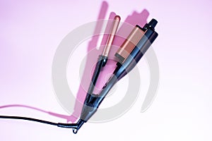 Multi-Styler for hair. curling iron. on a pink background. space for text, free space for copy space