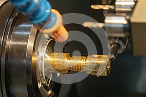 The multi-tasking CNC lathe machine swiss type milling the brass shaft parts