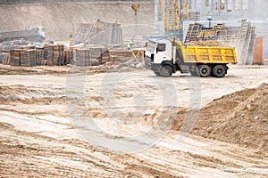 Multi-ton heavy mining dump truck loaded during removal of construction soil from construction site. Concept of