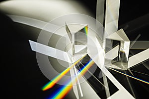 Multi triangular Prism dispersing sun beam splitting into a spectrum on white background