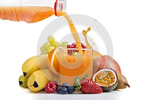 Multi vitamine fruit juice being poured from bottle