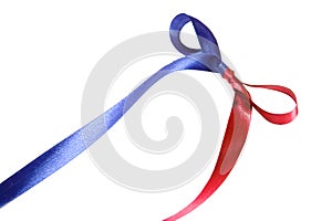 Multicolor blue-red fabric ribbon and bow on white background