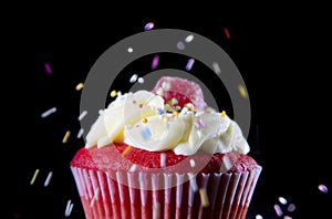 Multicolor candy topping pouring on strawberry delicious cupcake muffin in sugar temptation concept