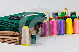 Multicolor cotton thread spools for sewing.