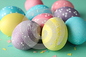 Multicolor Easter eggs on mint background