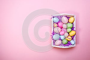 Multicolor eggs in a white tray. Creative Easter concept. Modern