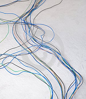 multicolor electric wire long line on concrete floor. many plastic cover copper prepare install in new construction house