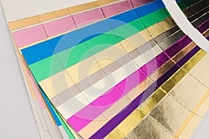 Multicolor hotfoil paper sampler isolated on white