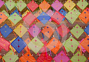 Multicolor kites are set or hang on rope and pole to many rows and stack with morning light