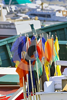 multicolor net marker flags on a traditional fishing boat