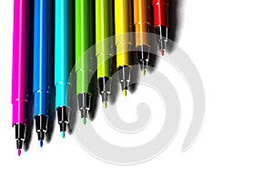 Multicolor pens on white background