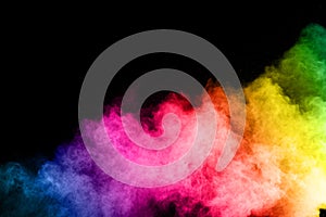 Multicolor powder explosion on black background.