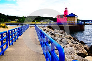 Multicolor scene with a bright pink beacon and a blue fence on the pier. Colorfull Holland Harbor Light,