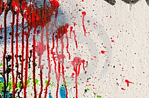 Multicolor textured background on a white wall. Blood ink splatter