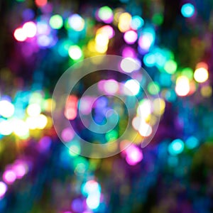 Multicolored abstract shiny background with bokeh, defocused Christmas lights. Festive concept. Selective focus.