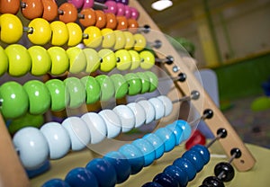 Multicolored Bill Counters, Educational Wooden Rainbow Game Closeup. Healthy Happy Children Learn to Count Indoors at the