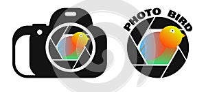 Multicolored bird peeps out of camera lens. Creative logo for a photo studio and professional photographer. World Photography Day