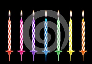 Multicolored birthdays candles isolated on black background
