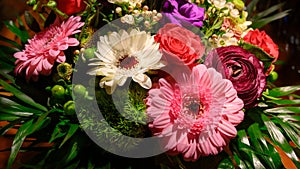 Multicolored blooming spring flower bouquet with red rose pink buttercup and white and pink gerbera.