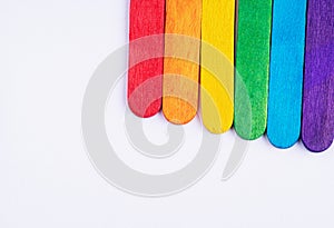 Multicolored boards in colors of rainbow on a white background. Background texture of colorful wooden planks