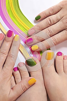 Multicolored bright manicure and pedicure