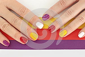 Multicolored bright saturated manicure on short nails close-up.