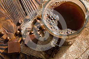 Multicolored bubbles in glass Cup of espresso coffee on old wooden table