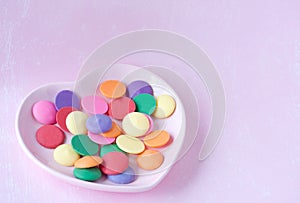 Multicolored candy melts in the heart shaped plate