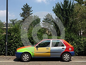 Multicolored car parked in city street