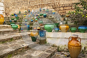 Multicolored ceramics containers and artifacts displayed along the steps at the Ceramics Quarter in Grottaglie