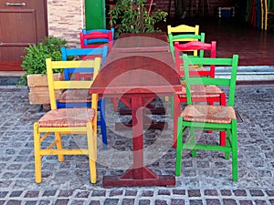 Multicolored chairs in outdoor greek restaurant, Crete, Greece.