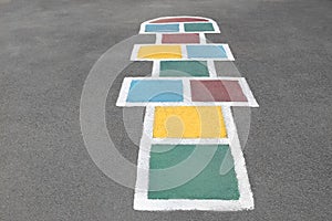 Multicolored classics painted on the road. Game for children