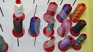 Multicolored colored threads. sewing shop. rolls of thread in the factory production of fabrics