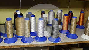 Multicolored colored threads. sewing shop. rolls of thread in the factory production of fabrics